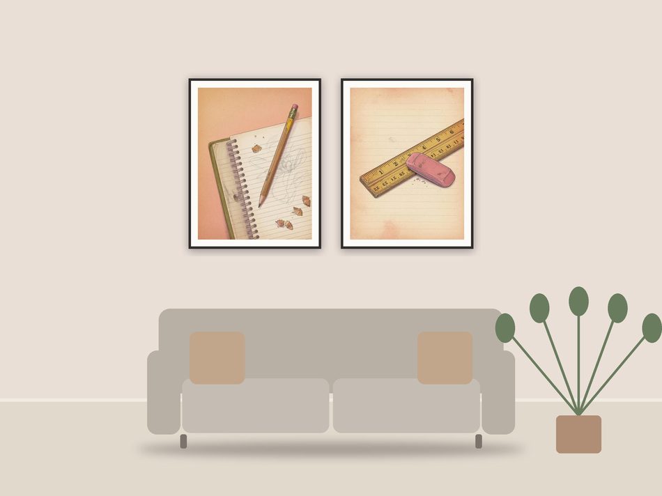 vintage classroom objects printable art framed above a sofa in a styled living room